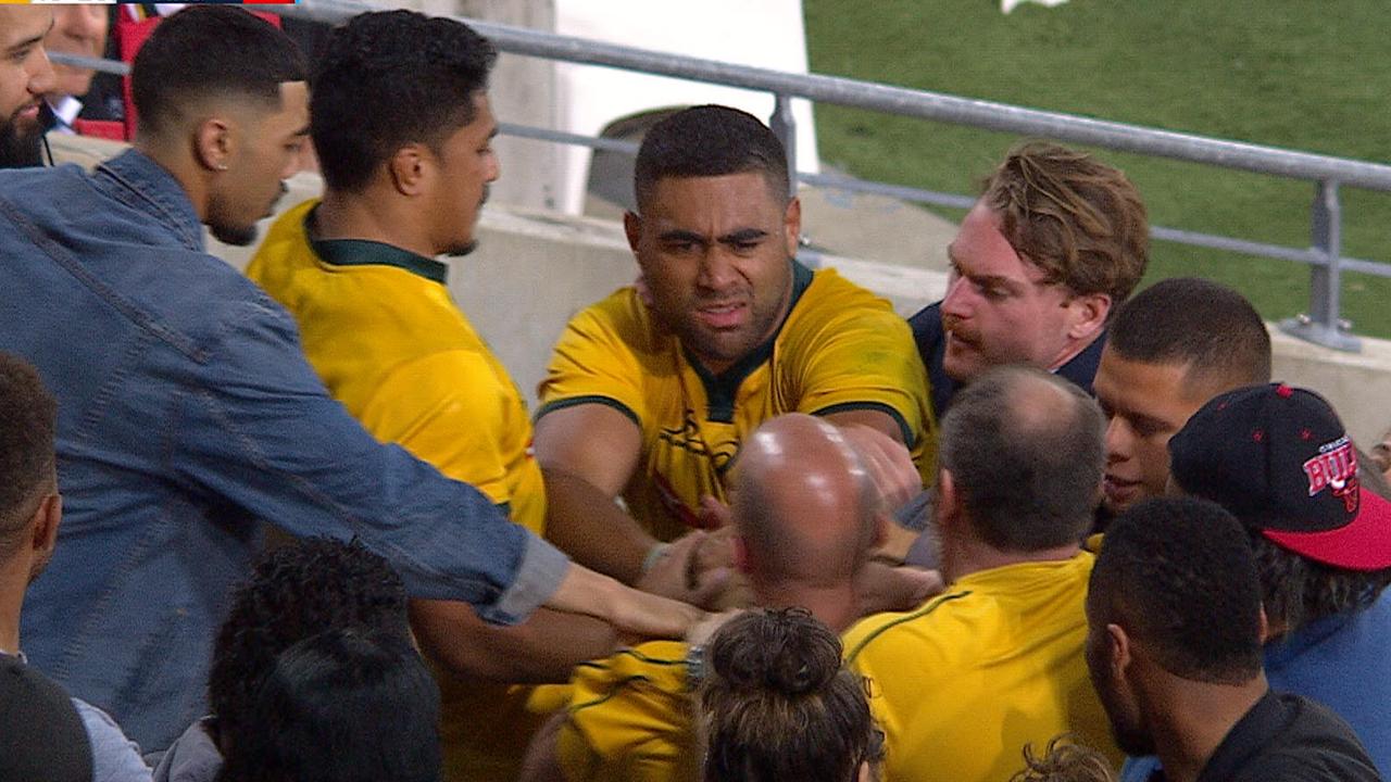 A fan grapples with Wallabies forward Lukhan Tui after Australia's loss to Argentina at Cbus Super Stadium.