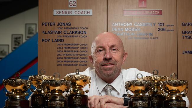 Roy Laird with the seven SANFL premiership cups he won as Central District coach. Picture: Naomi Jellicoe