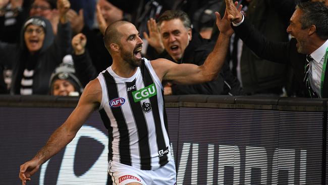 Steele Sidebottom celebrates a goal with a fan.