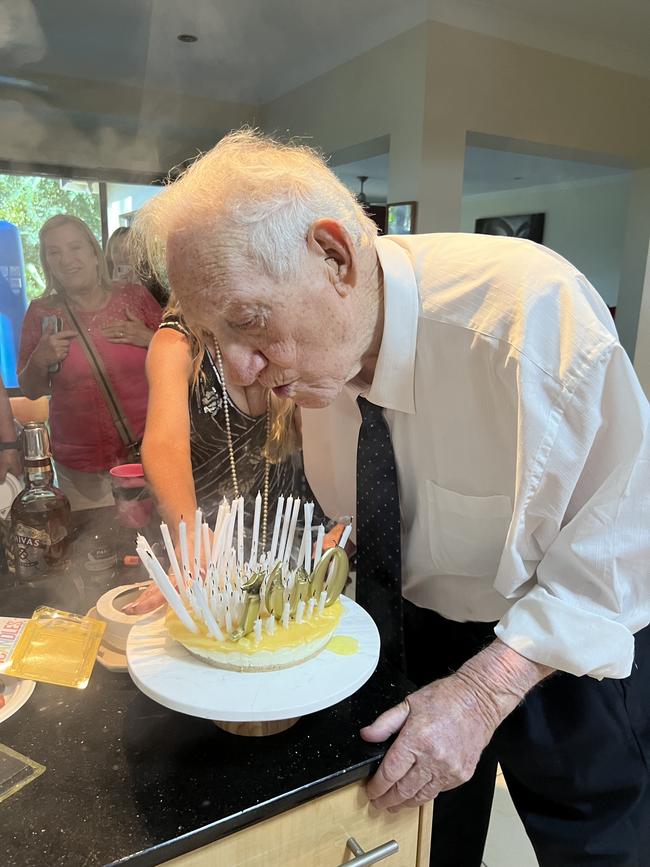 World War II veteran Keith Arneman blows out the candles on his cake at his 100th birthday party.