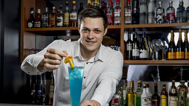 Skyline head bartender Luke Baericke putting the final touches to a Long Island Blue cocktail. Picture: Jerad Williams