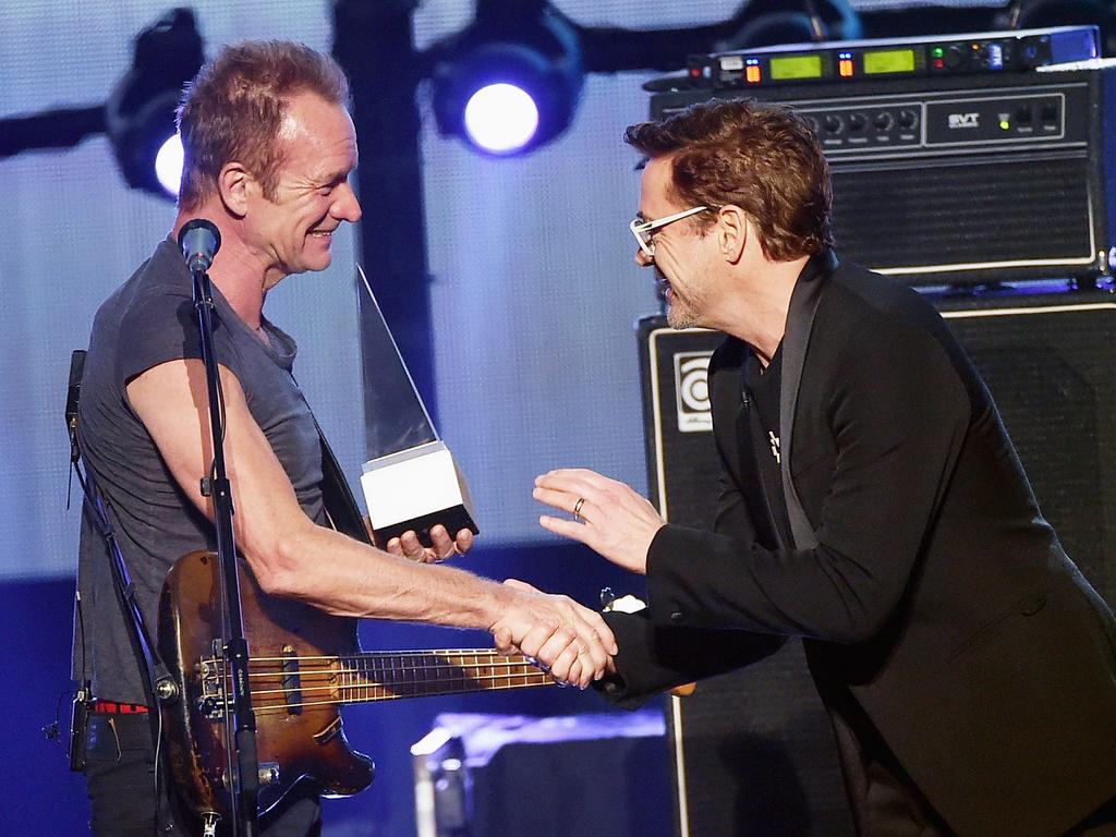 Musician Sting accepts the Award of Merit from actor Robert Downey Jr. onstage during the 2016 American Music Awards at Microsoft Theater on November 20, 2016 in Los Angeles, California. Picture: Getty