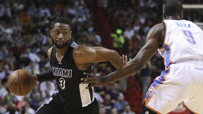 Miami Heat's Dwyane Wade (3) drives around Oklahoma City Thunder's Serge Ibaka (9).