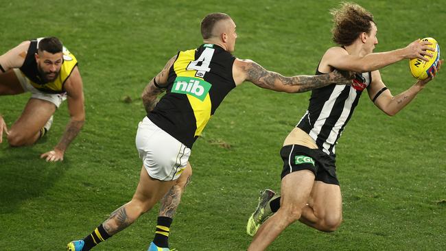 Chris Mayne of the Magpies is challenged Dustin Martin of the Tigers during the round 2 AFL match between the Collingwood Magpies and the Richmond Tigers at Melbourne Cricket Ground on June 11, 2020 in Melbourne, Australia. Picture: Getty Images