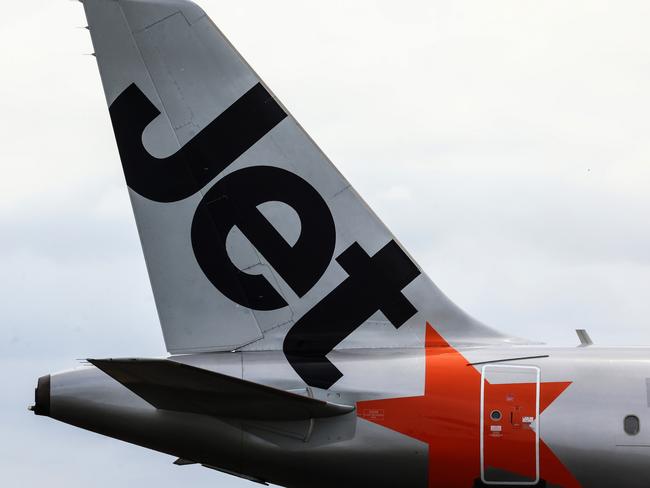 SYDNEY, AUSTRALIA - JANUARY 20: The Jetstar logo displayed on an aircraft tail at Sydney Airport  on January 20, 2024 in Sydney, Australia. Transport Minister Catherine King signed off on a deal that will allow Turkish Airlines to start serving the Australian market, rising to 35 flights a week by 2025. The decision came as the government was under mounting criticism from many for a perception that it was protecting the profits of Qantas and stymying competition in the market by limiting additional capacity for other carriers, such as Qatar Airways. (Photo by Jenny Evans/Getty Images)