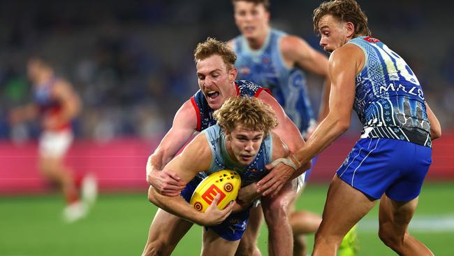 MELBOURNE, AUSTRALIA – MAY 21: Jason Horne-Francis of the Kangaroos is tackled during the round 10 AFL match between the North Melbourne Kangaroos and the Melbourne Demons at Marvel Stadium on May 21, 2022 in Melbourne, Australia. (Photo by Graham Denholm/Getty Images)