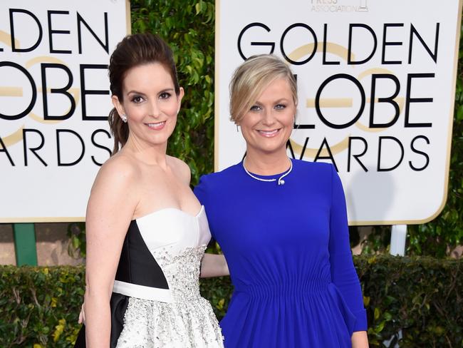 Hosts Tina Fey and Amy Poehler hit the red carpet together.