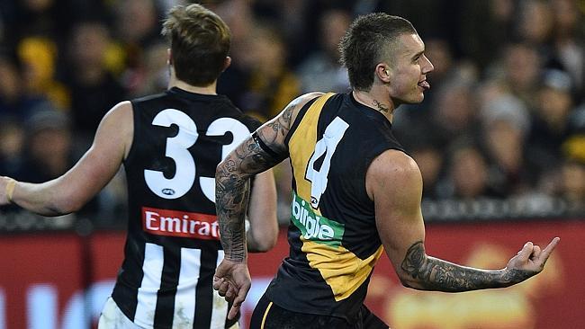 Dustin Martin of the Tigers (right) reacts after kicking a goal during the round 20 AFL match between the Richmond Tigers and Collingwood Magpies at the MCG in Melbourne, Friday, Aug. 5, 2016. (AAP Image/Julian Smith) NO ARCHIVING, EDITORIAL USE ONLY