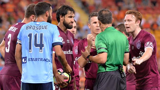 Players from both sides show their frustration at referee Alan Milliner during the round seven A-League match between the Brisbane Roar and Sydney FC at Suncorp Stadium.