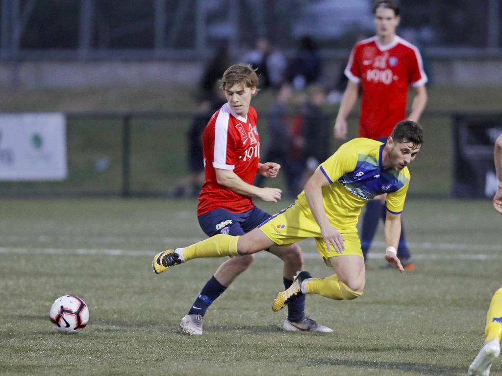 Lokoseljac Cup Final at KGV. Devonport Strikers versus South Hobart. Devonport's Joel Stone goes down after a challenge with South Hobart's Bradley Lakoseljac. Picture: PATRICK GEE