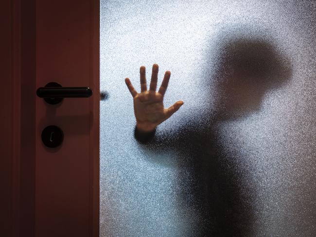 Blurred sad boy leaning open hand against glass door. TSS (The Southport School) stock photo. Photo: iStock