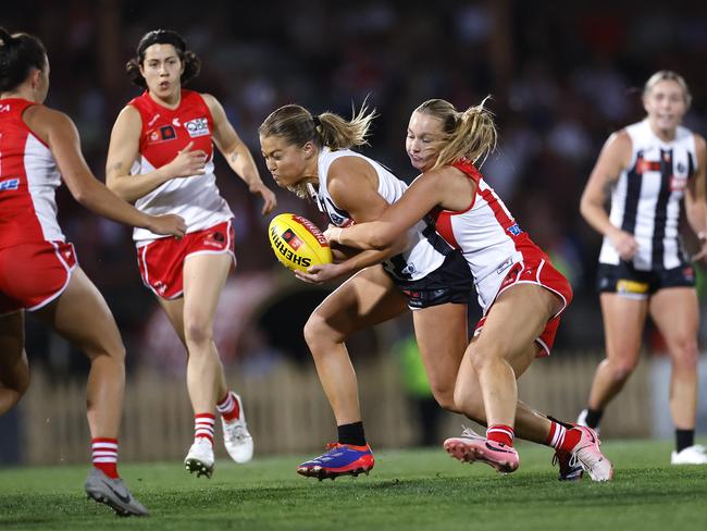 Collingwood’s Sarah Rowe is tackled by the Swans’ Sarah Grunden. Picture: Phil Hillyard