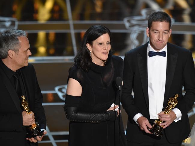 Dirk Wilutzky, from left, Laura Poitras and Glenn Greenwald accept the award for best documentary feature for “Citizenfour” at the Oscars on Sunday, Feb. 22, 2015, at the Dolby Theatre in Los Angeles. (Photo by John Shearer/Invision/AP)