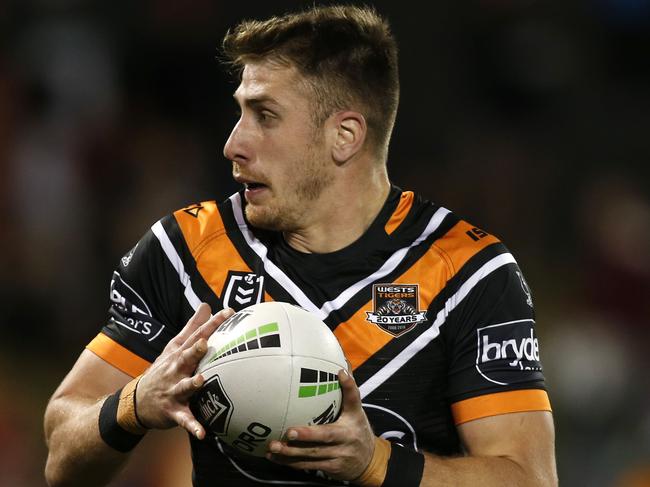 Paul Momirovski of the Tigers makes a run from an intercept during the Round 23 NRL match between the Wests Tigers and the Newcastle Knights at Campbelltown Stadium in Sydney, Saturday, August 24, 2019.  (AAP Image/Darren Pateman) NO ARCHIVING, EDITORIAL USE ONLY