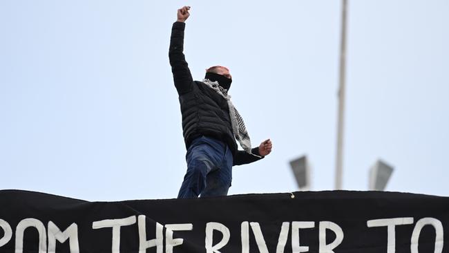 A protester on the roof of Parliament House. Picture: NewsWire/ Martin Ollman