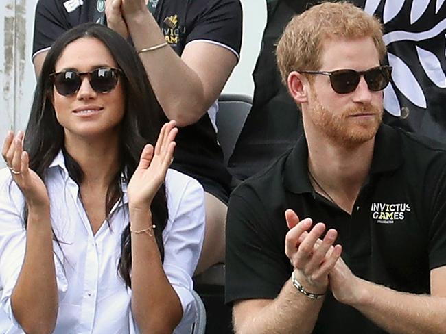 Prince Harry (R) and then-girlfriend Meghan attend a wheelchair tennis match during the Invictus Games 2017. Picture: Getty