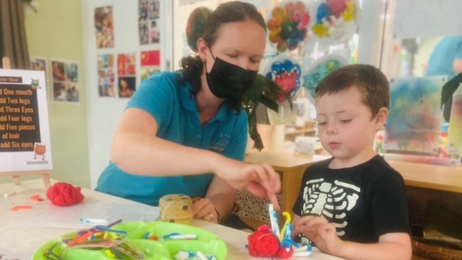 Preschool teacher Kym Borra shows student Archer a Halloween maths activity at First Steps Early Learning in Lismore.