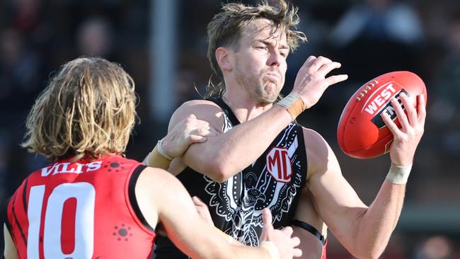 Port Adelaide’s Trent Dumont battles for the ball with West Adelaide’s Kobe Ryan at Alberton Oval on Saturday. Picture: David Mariuz/SANFL.