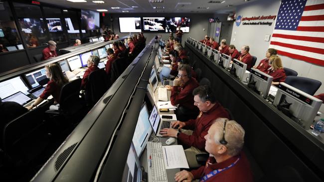 Engineers monitor the landing of InSight in the mission support area of the space flight operation facility at NASA's Jet Propulsion Laboratory. Picture: AP