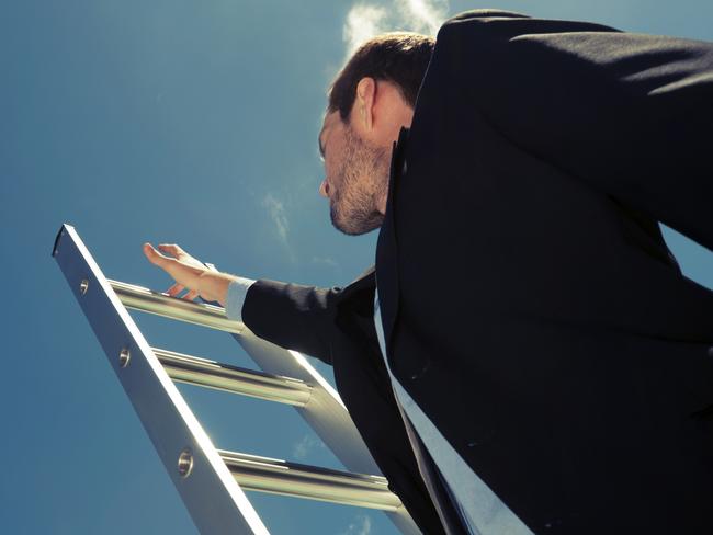 Businessman climbing the Ladder of success with blue sky background and copy space. Cross processedFor LIFE story