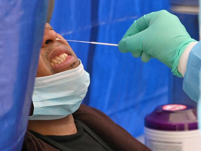 (FILES) In this file photo taken on May 08, 2020, ahealthcare worker takes a nasal swab sample to test for the coronavirus at the Brightpoint Health and UJA-Federation of New York free pop-up coronavirus testing site in the Brooklyn borough of New York City. - New York City will require public hospital workers to get vaccinated or take a weekly coronavirus test, Mayor Bill de Blasio said on July 21, 2021, as the metropolis faces an uptick in cases fueled by the Delta variant. The order will go into effect from August 2 and apply to the some 30,000 employees in the city's 11 public hospitals. (Photo by Angela Weiss / AFP)