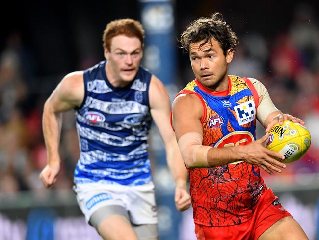 Jarrod Harbrow (right) of the Suns in action during the Round 10 AFL match between the Gold Coast Suns and the Geelong Cats at Metricon Stadium on the Gold Coast, Saturday, May 25, 2019. (AAP Image/Darren England)