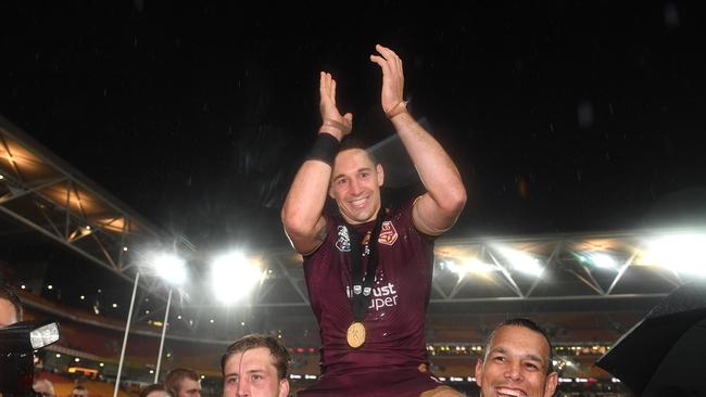 Billy Slater of the Maroons is chaired from the field by Cameron Munster (left) and Will Chambers following Game 3 of the 2018 State of Origin series between the NSW Blues and the Queensland Maroons at Suncorp Stadium in Brisbane, Wednesday, July 11, 2018. (AAP Image/Dave Hunt) NO ARCHIVING, EDITORIAL USE ONLY