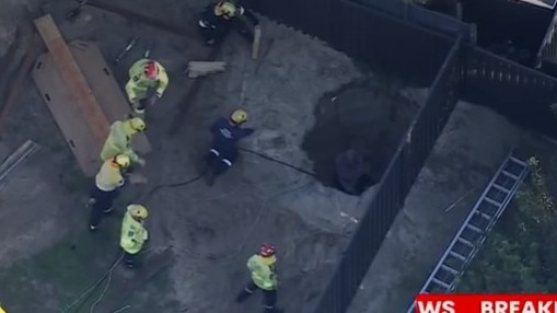 WA Fire and Rescue crews are working to rescue the man from a backyard hole in Hillarys, Perth. Picture: 7News