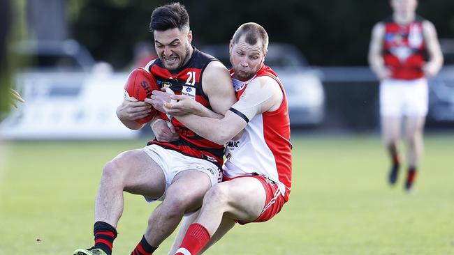 Ryan Bailey (Clarence) wraps up Phil Bellchambers in a strong tackle. Picture: ZAK SIMMONDS