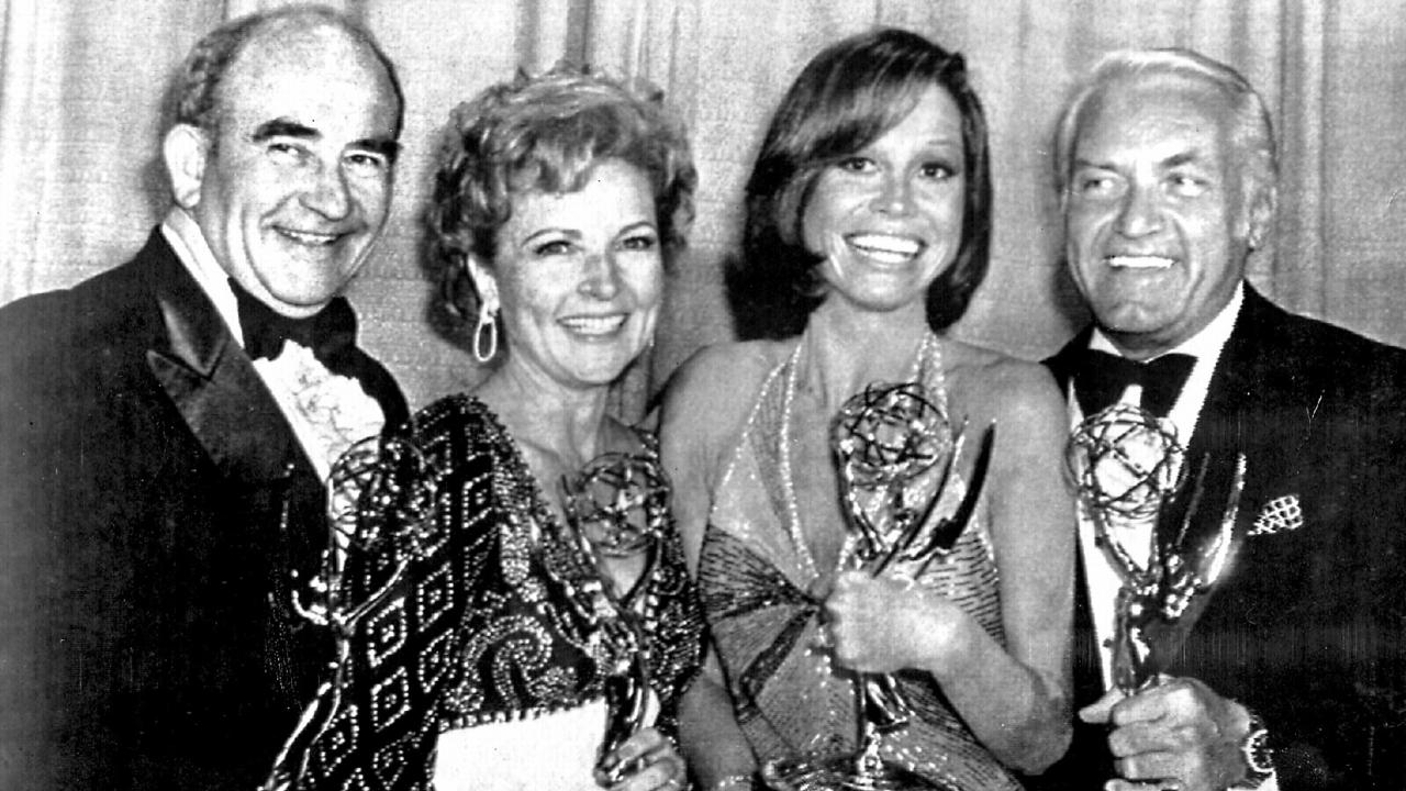 White (second from left) with the cast of The Mary Tyler Moore Show; Ed Asner, Mary Tyler Moore and Ted Knight at the 1976 Emmy Awards.