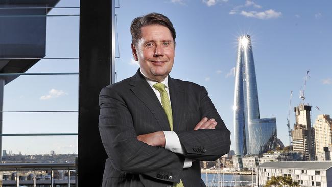 The Star CEO Matt Bekier pictured on the balcony of The Sovereign Room at The Star casino in Pyrmont with the Crown tower at Barangaroo in the background. The Star has proposed a merger with Crown Group. Picture: Toby Zerna