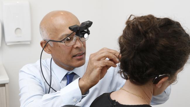 Ear, nose and throat Professor Melville da Cruz examines a patient.