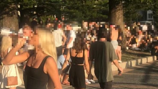 A girl swigs out of a wine bottle at “The Office” on East Esplanade, Manly. Picture: Supplied.