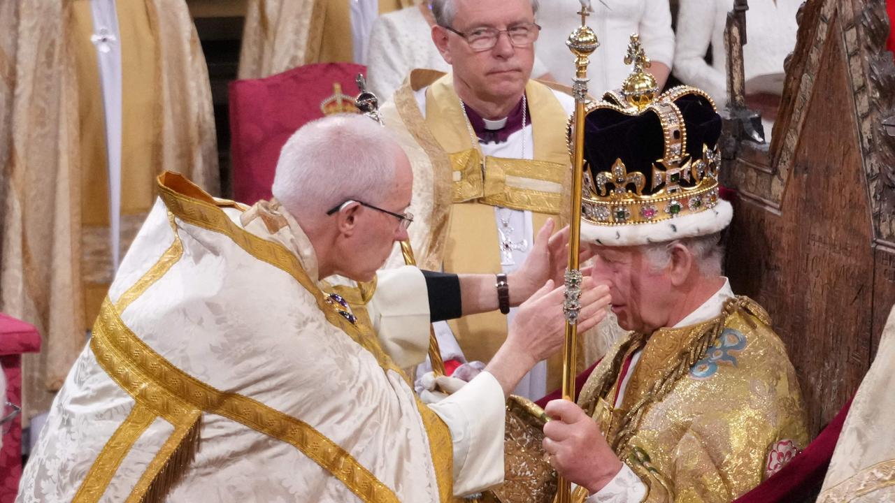 The Archbishop of Canterbury Justin Welby places the St Edward's Crown onto the head of Britain's King Charles III during the Coronation Ceremony inside Westminster Abbey in central London on May 6, 2023. (Photo by Victoria Jones / POOL / AFP)