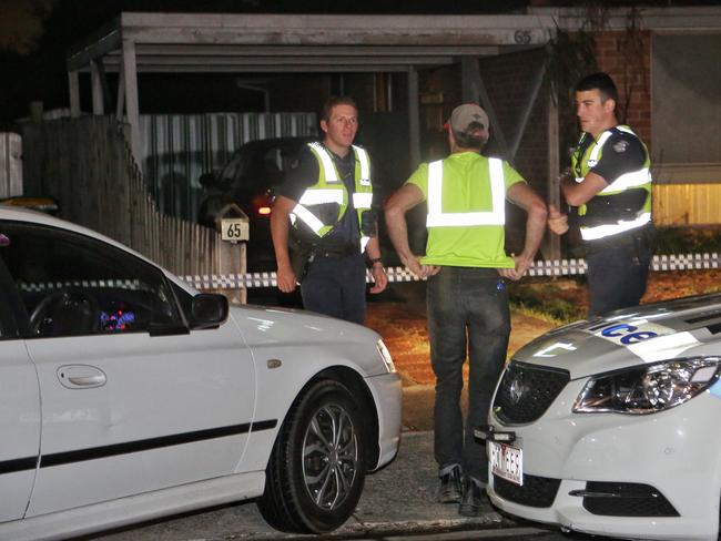 Police speak with Ms Stuart’s partner outside the home. Picture: Hamish Blair