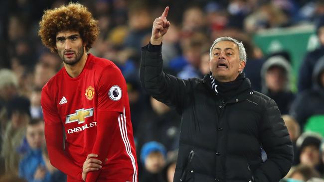 Jose Mourinho manager of Manchester United stands alongside substitute Marouane Fellaini