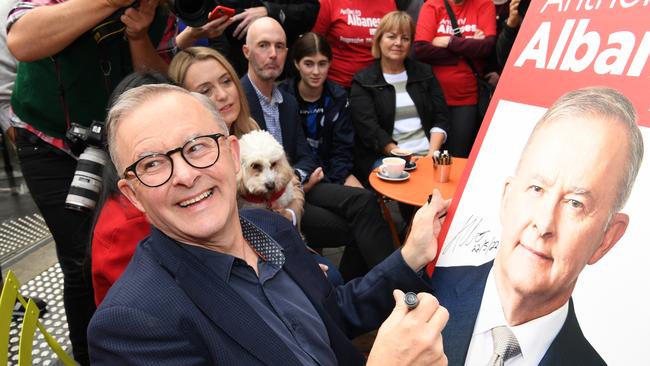 Prime Minister elect Anthony Albanese signs a poster for a young boy near his home on May 22. Picture: Getty Images