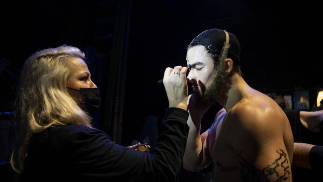 Head of hair, wigs and makeup Kellie Ritchie gives cast member Jakob Ambrose a touch up behind the scenes at Frozen the Musical. Picture: Lisa Tomasetti