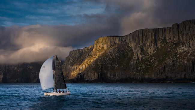 Midnight Rambler passing Tasman Island, photo from Tasmanian photographer Andrew Wilson’s tribute to the iconic Sydney to Hobart yacht race, Blue Water Classics.