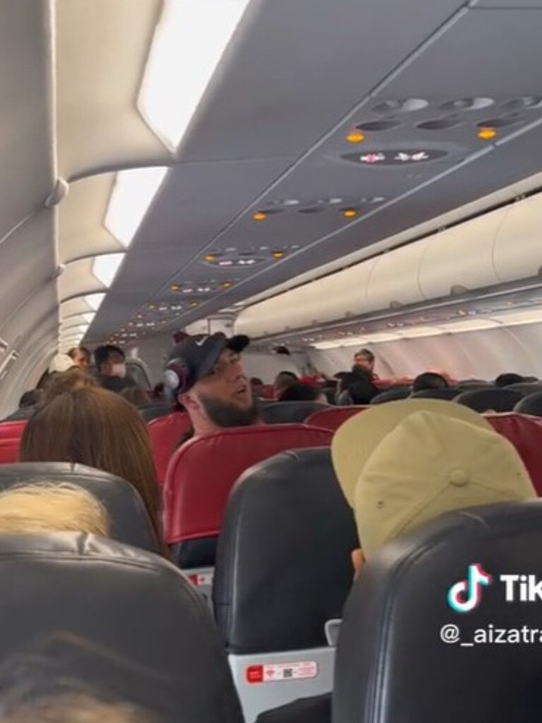 The men were filmed yelling at passengers at the back of the plane.