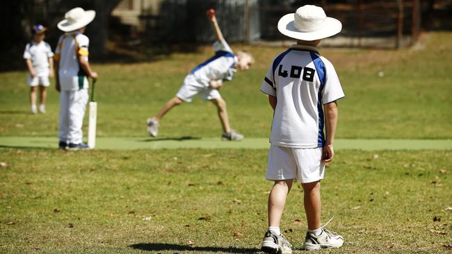 Children in the Under 8's Cricket competition wear black armbands and have a minutes silence before playing in Putney today. Tom Bermingham 8, of the RHH Blackbeards wears the number 408 on his back as a tribute to Hughes.
