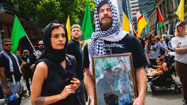 Protesters in Melbourne on Sunday display a framed picture of Sinwar.