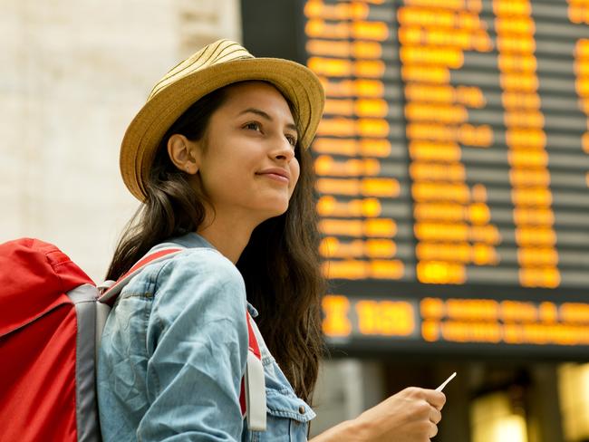 ESCAPE: EURAIL .. John Borthwick story .. Young woman checking her train in time board. Picture: iStock