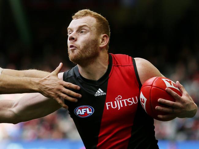 AFL Round 21 : Essendon v Gold Coast Suns at Etihad Stadium, Essendon's Adam Cooney pushes off Gold Coast Suns' Jarrod Harbrow. 14th August 2016. Picture: Colleen Petch.