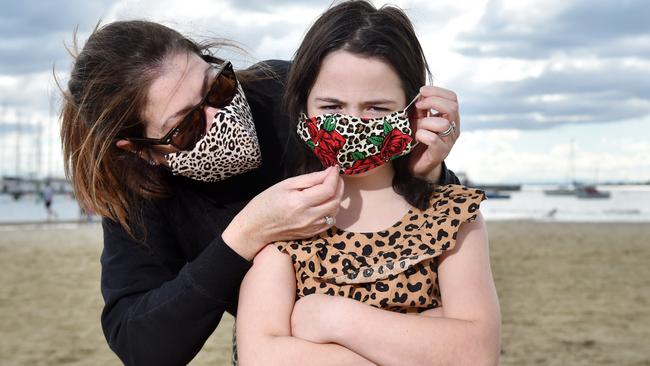 Frankie, 7, has her mask placed on her by mum Tara. Picture: Nicki Connolly