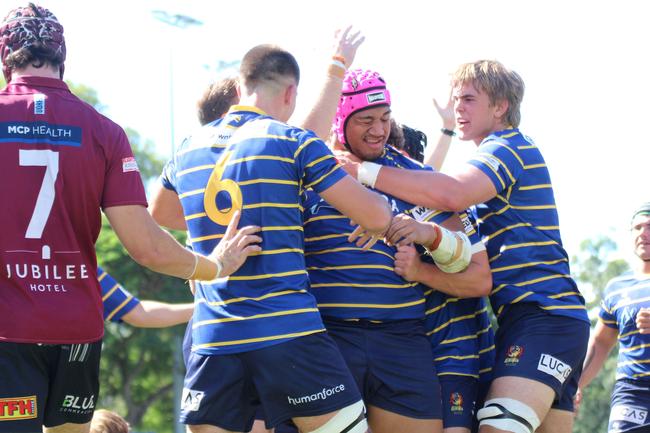 Joe Stoddart (No.6) Tom Nadenic (right) get around PJ Su'a during round 5 of the Colts 1 rugby season.