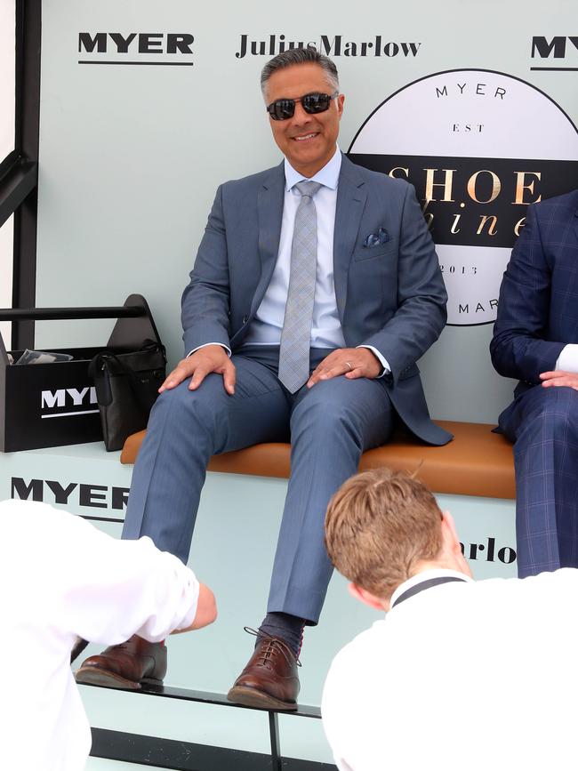 Then Australia Post CEO Ahmed Fahour having his shoes shined in the birdcage at the 2015 Melbourne Cup.