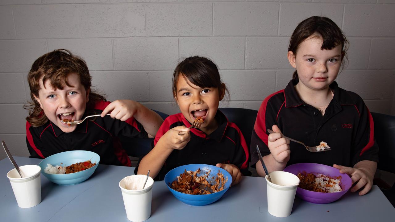 Students Taj Schramm, Natalia Benjamin, and Layla Edler enjoying their Mexican rice and yoghurt at Clarendon Vale Primary School. Picture: Linda Higginson