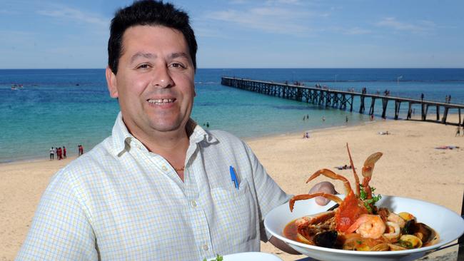 Mr Horta holding a plate of caramelised scallops and seafood bouillabaise. Picture: File