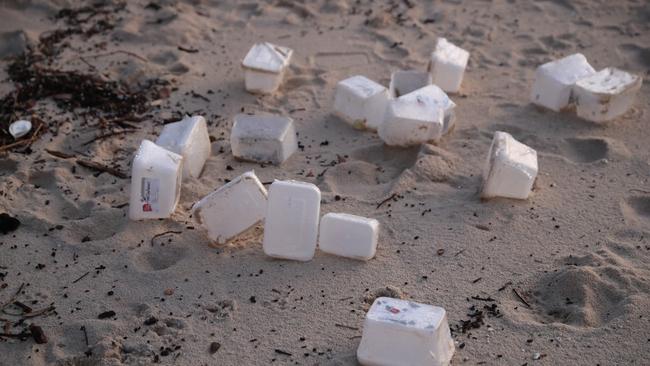 Items washed up from damaged containers lost from a ship, including packets of bread crumbs, Tupperware containers and surgical masks. Picture: John Grainger